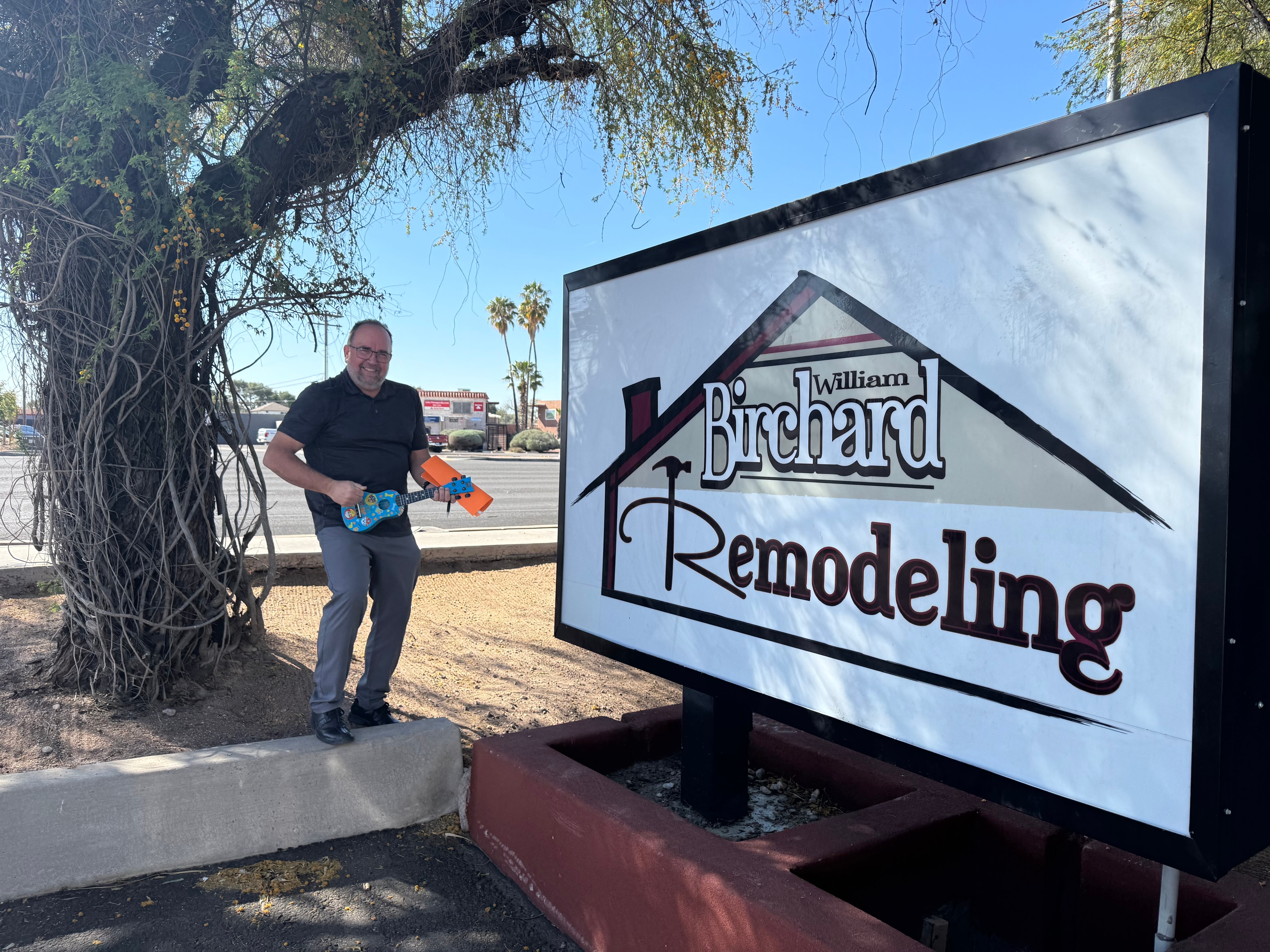 BJ Birchard standing next to the William Birchard Remodeling showroom sign in Tucson, AZ