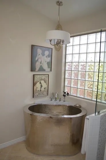 Luxury soaking tub with pendant lighting and glass block window — Birchard Remodeling Tucson